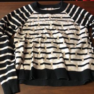 Black and white striped sweater with gold detailing